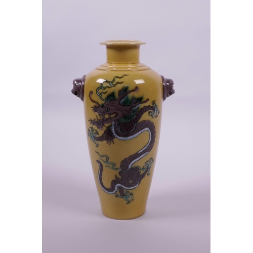 63 - A Chinese sancai glazed porcelain vase with two lion mask handles and dragon decoration, 6 character... 