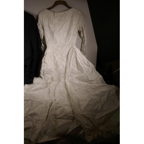 66 - A white satin wedding dress from Marshall and Snelgrove, and a Christian Dior blue pin striped suit