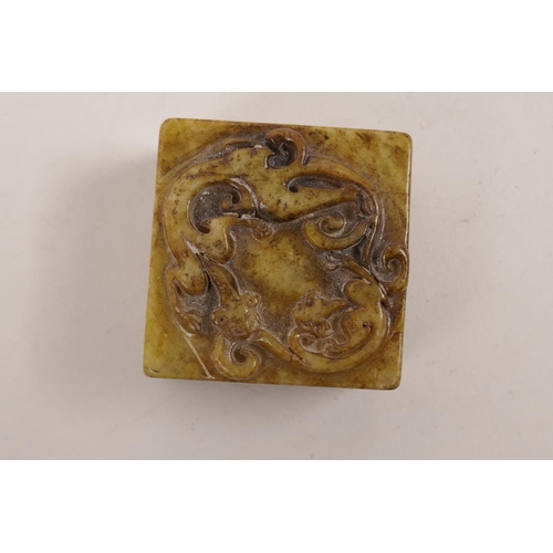 67 - A Chinese hardstone square form seal with carved dragon decoration to top, 2