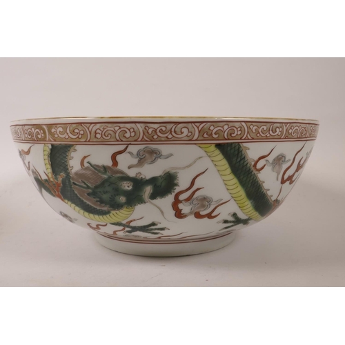 107 - A C19th Chinese famille verte porcelain bowl decorated with dragons chasing the flaming pearl in bri... 