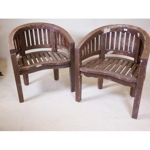 1206 - A pair of teak bow back garden chairs