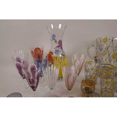 14 - A quantity of decorative coloured and enamelled glassware including jugs, carafe etc