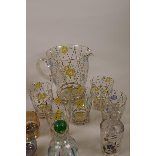 14 - A quantity of decorative coloured and enamelled glassware including jugs, carafe etc