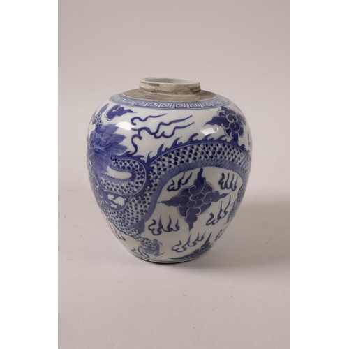 28 - A C19th blue and white ginger jar decorated with a dragon chasing the flaming pearl, 5½