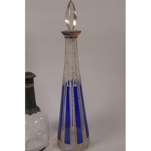 29 - A conical flash cut blue and clear glass decanter and stopper with gilt embellishments, 14½