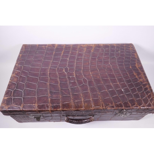 38 - A vintage crocodile skin suitcase, 26