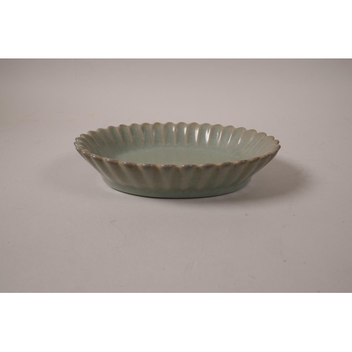 55 - A Chinese celadon crackle glazed dish with a petal shaped rim, 7