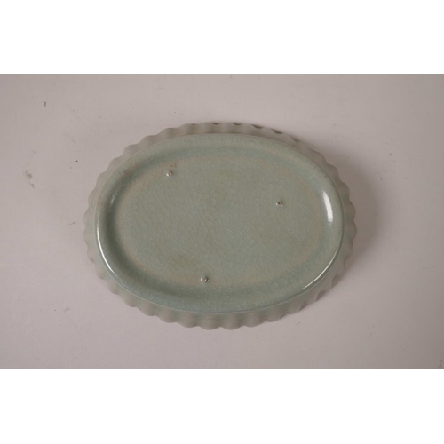 55 - A Chinese celadon crackle glazed dish with a petal shaped rim, 7