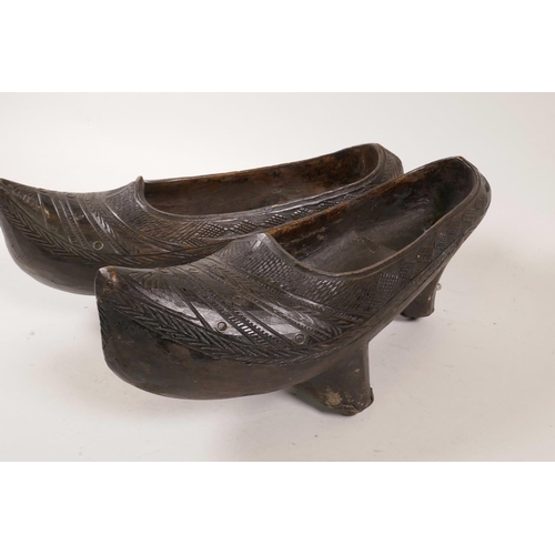 61 - A pair of C19th Cantabria wooden clogs with carved decoration, 12½