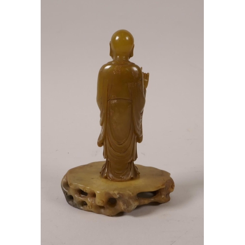 65 - A fine Chinese carved soapstone figure of lohan, with a stand and carved hardwood fitted box, the co... 