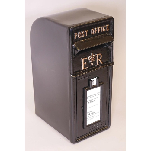 72 - A black metal post box with cast iron front and metal shell, 23