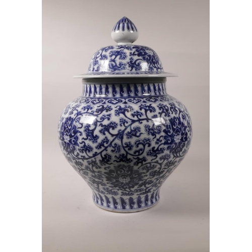 78 - A large Chinese blue and white pottery baluster jar and cover with scrolling lotus flower decoration... 