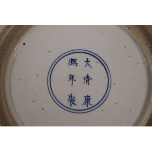 20 - A Chinese famille verte porcelain charger decorated with a courting couple, 6 character mark to base... 