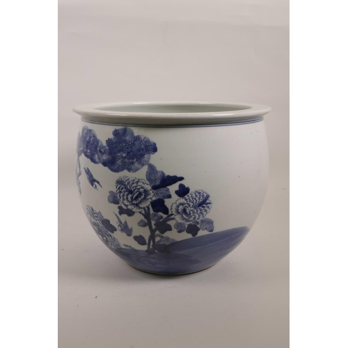 31 - A large Chinese blue and white porcelain jardiniere decorated with birds and flowers in a landscape,... 