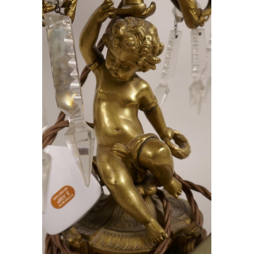 32 - A Continental ormolu two branch table lamp, with putti decoration, 15½