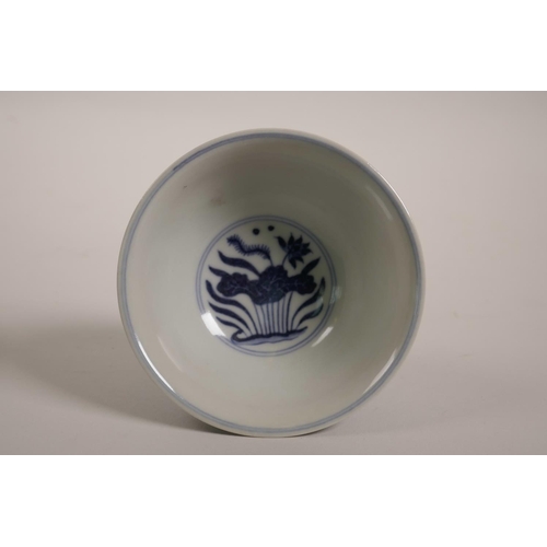 43 - A Chinese blue and white porcelain stem cup decorated with carp in a lotus pond, 6 character mark to... 