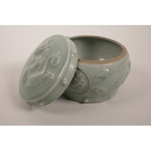 55 - A Chinese celadon crackle glazed porcelain box and cover in the form of a barrel with raised floral ... 