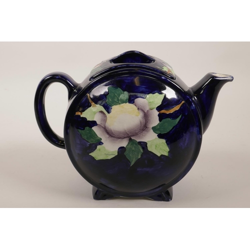 37 - A vintage Maling of Newcastle barrel pattern pottery teapot painted with flowers on a dark blue grou... 