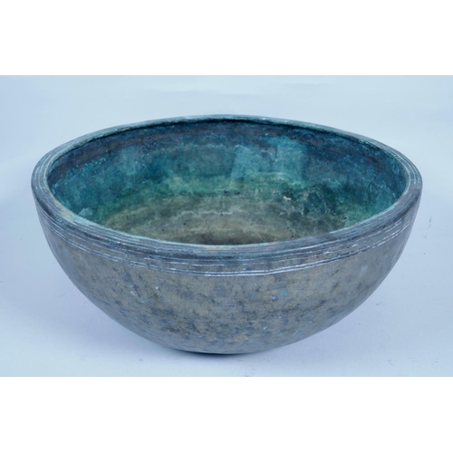 29 - An Indian hammered white metal bowl, 10½