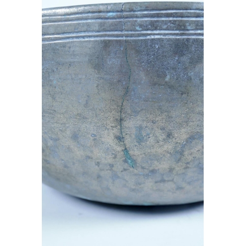 29 - An Indian hammered white metal bowl, 10½