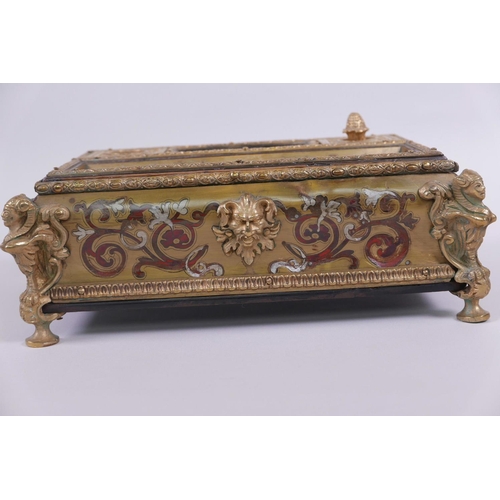 30 - A French boullework and ormolu desk stand, with two inkwell compartments and pen tray, raised on win... 