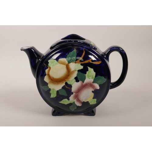 37 - A vintage Maling of Newcastle barrel pattern pottery teapot painted with flowers on a dark blue grou... 