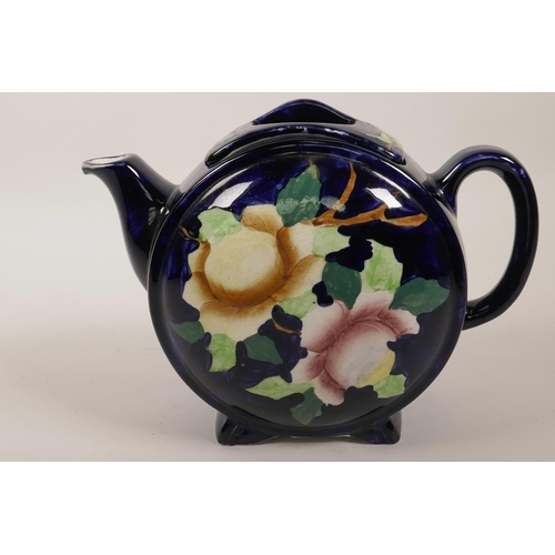 37 - A vintage Maling of Newcastle barrel pattern pottery teapot painted with flowers on a dark blue grou... 