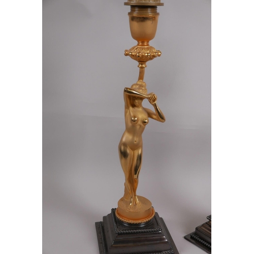 38 - A pair of Art Deco style ormolu table lamps cast in the form of nudes, on polished steel bases, 16