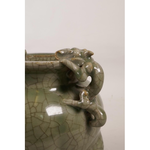 55 - A Chinese green crackle glazed porcelain censer on tripod feet with two dragon handles, 6