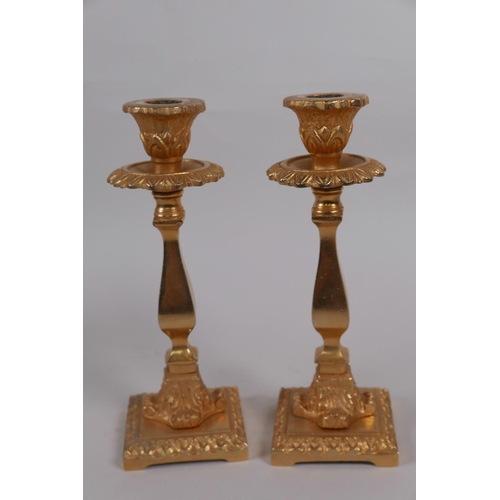 57 - A pair of cast ormolu candlesticks with shaped square section columns, 6¾