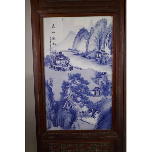 61 - A pair of Chinese blue and white porcelain panels depicting riverside landscapes with temples, in ha... 