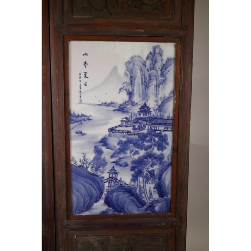 61 - A pair of Chinese blue and white porcelain panels depicting riverside landscapes with temples, in ha... 