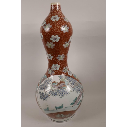 9 - A Chinese gourd shaped vase decorated with panels of exotic birds and flowers on a swirled red groun... 