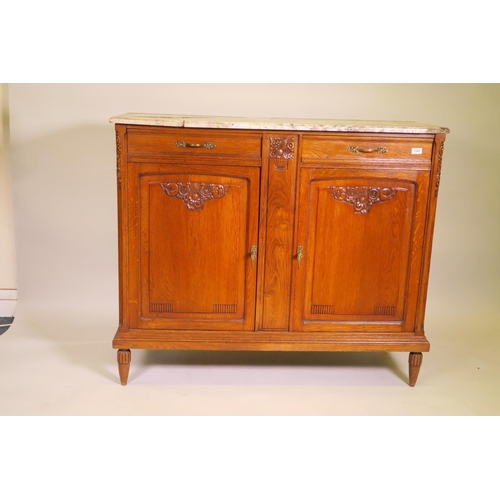 1196 - A French oak buffet with carved canted corners and marble top, A/F, and two drawers over two fielded... 