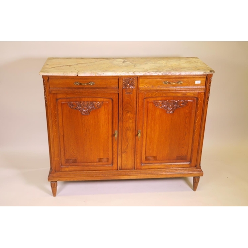 1196 - A French oak buffet with carved canted corners and marble top, A/F, and two drawers over two fielded... 