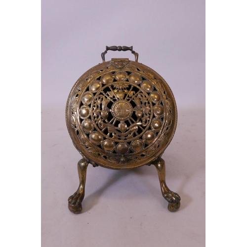 1181 - A Victorian brass barrel shaped coal scuttle on pawed feet with pierced decoration, 15