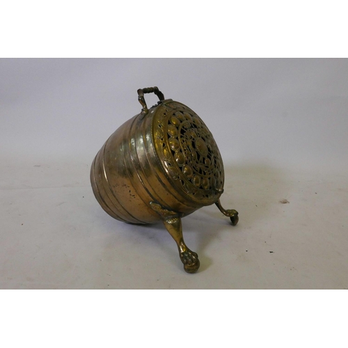 1181 - A Victorian brass barrel shaped coal scuttle on pawed feet with pierced decoration, 15