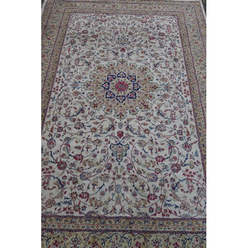 1205 - A Kashmiri ivory ground carpet with all over floral design and cream borders, 116