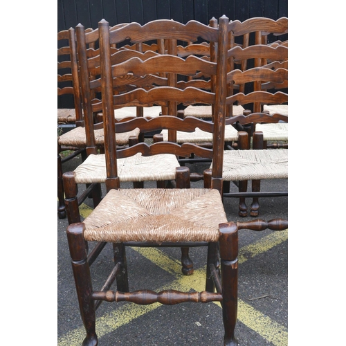 1206 - A long set of ten ash ladderback chairs with rush and seagrass seats, early C20th