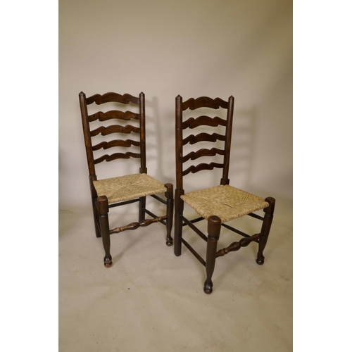 1206 - A long set of ten ash ladderback chairs with rush and seagrass seats, early C20th