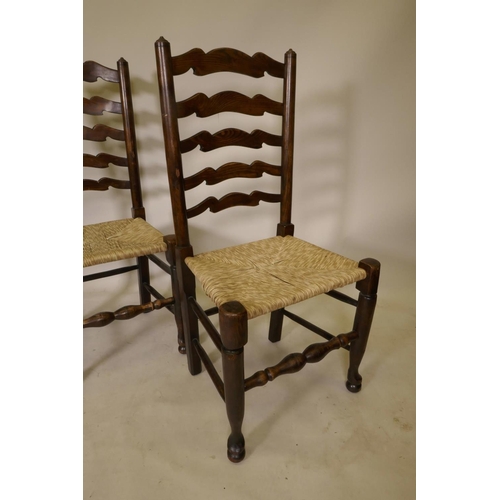 1206 - A long set of ten ash ladderback chairs with rush and seagrass seats, early C20th