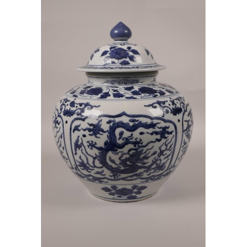 13 - A Chinese blue and white porcelain jar and cover with decorative panels depicting dragons in flight,... 