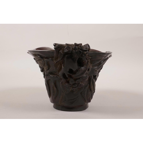 18 - A Chinese sectional horn libation cup with carved floral decoration, incised mark to base, 6