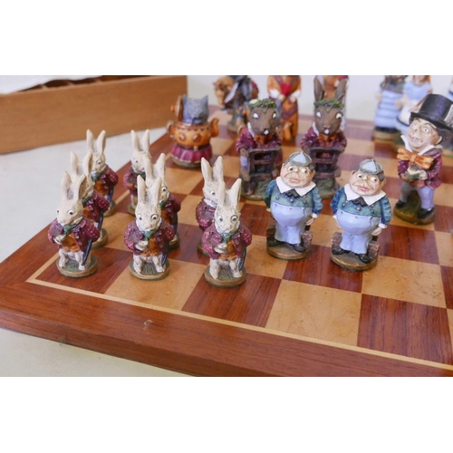 27 - An Alice Through the Looking Glass chess set, the hand painted models of cold cast marble, manufactu... 