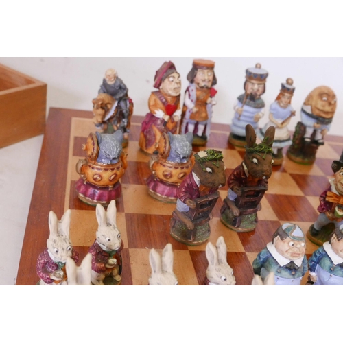 27 - An Alice Through the Looking Glass chess set, the hand painted models of cold cast marble, manufactu... 