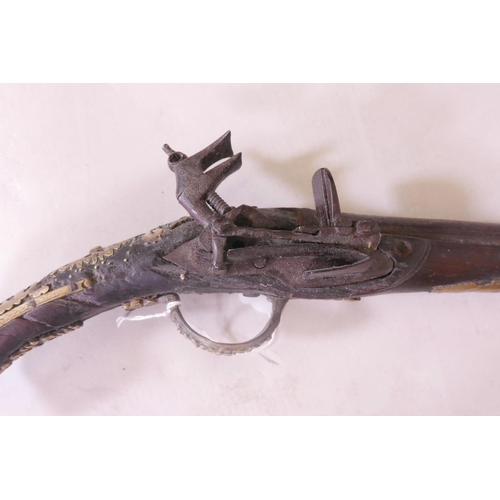 39 - An C18th Ottoman flintlock pistol, with pierced and engraved brass mounts and mother of pearl inlaid... 