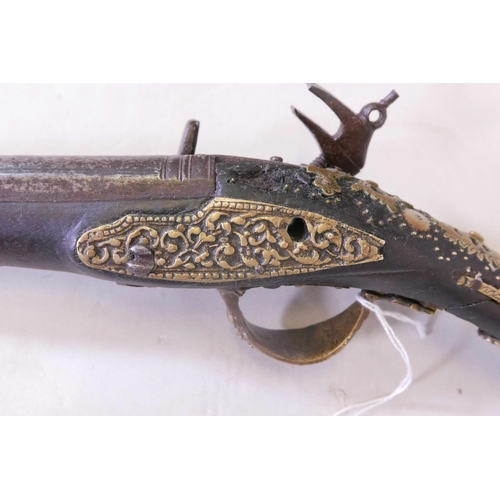 39 - An C18th Ottoman flintlock pistol, with pierced and engraved brass mounts and mother of pearl inlaid... 