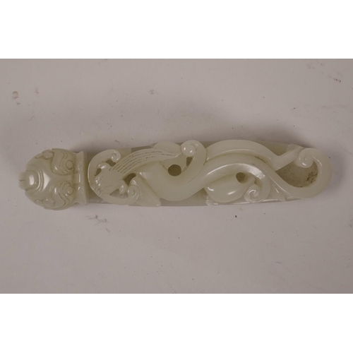 43 - A Chinese celadon jade belt hook with carved dragon decoration, 5½