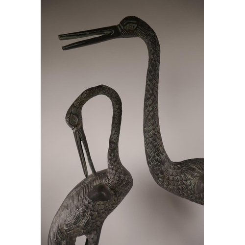 6 - A pair of metal garden figurines of cranes, largest 32