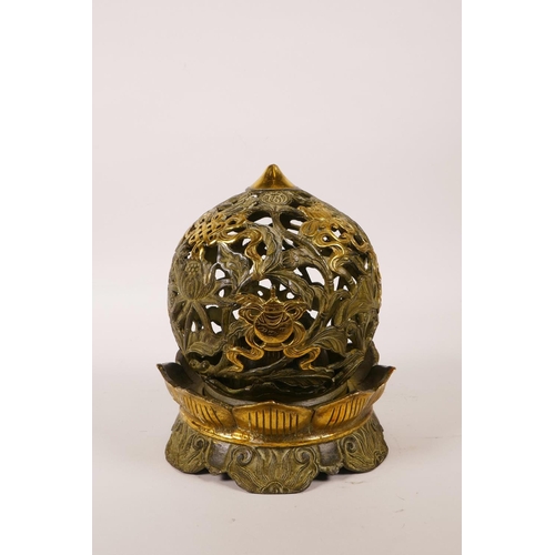 30 - A Chinese pierced bronze ball censer decorated with the eight Buddhist treasures, highlighted with g... 